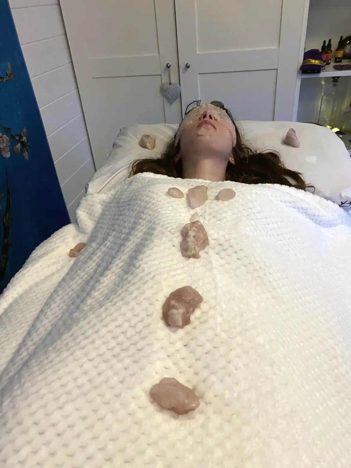 Rejuvenate Your Skin & Soul: Rose Quartz Reiki Facial Maidenhead Client laying on a Reiki bed in Maidenhead